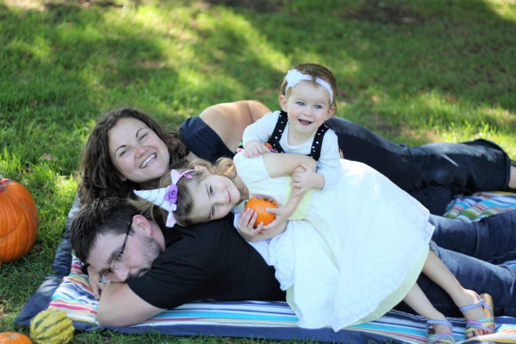 Our family lying on top of each other with baby on top