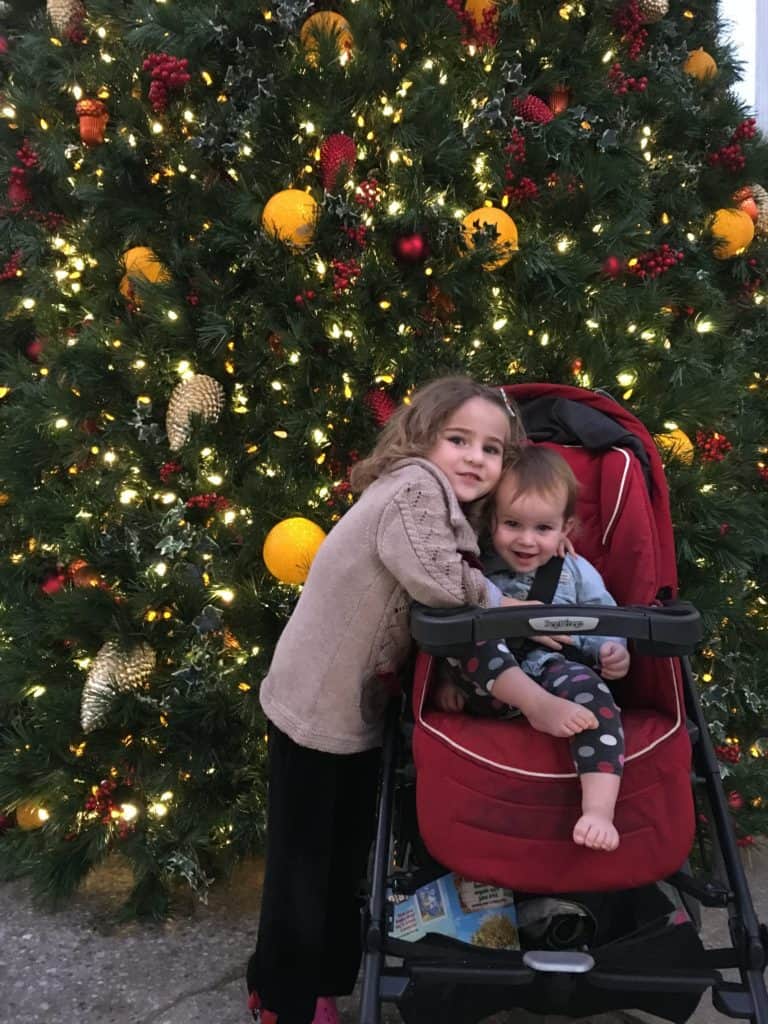 kids in front of Christmas tree