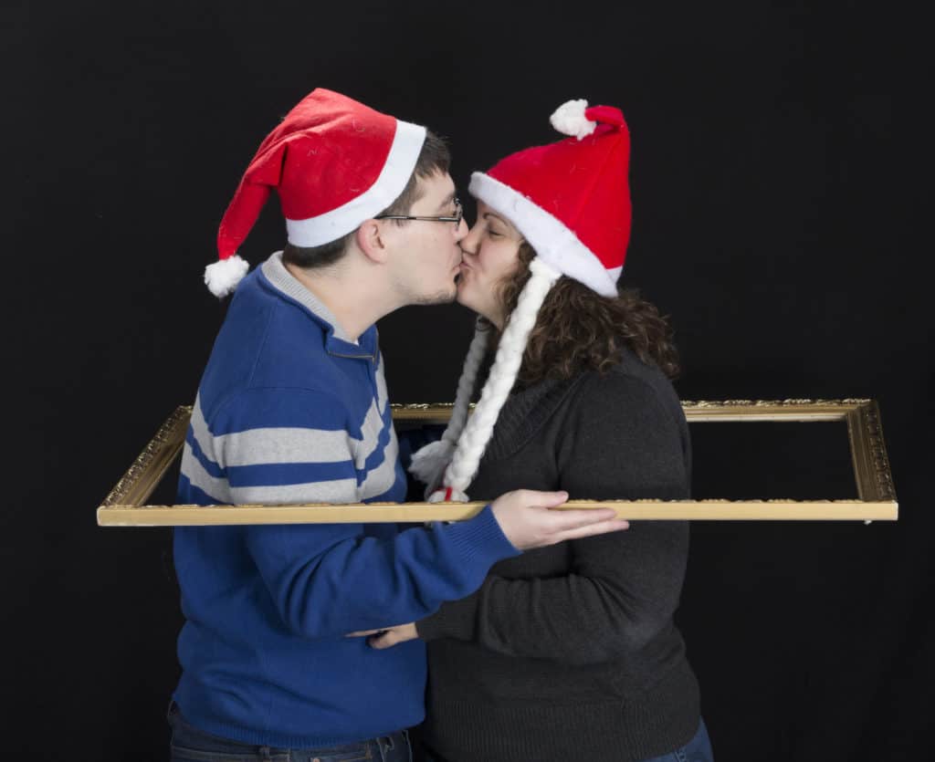 Holiday tradition kissing in santa hat