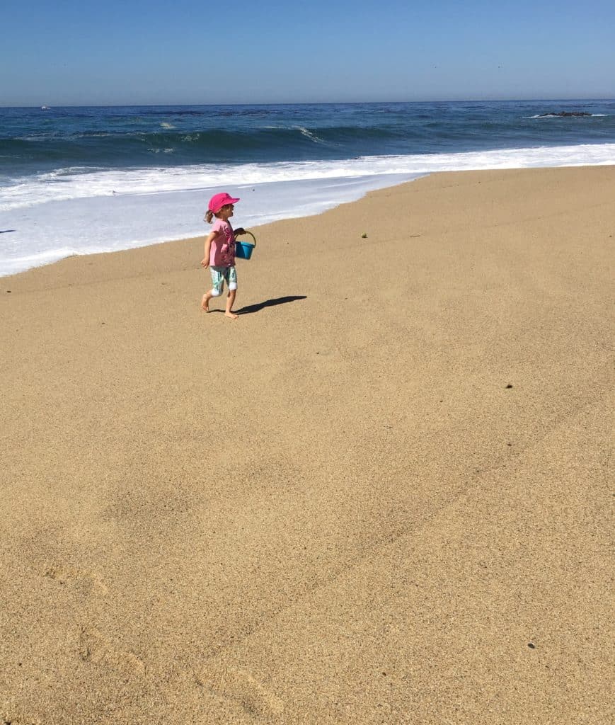 Kid on sandy Garrapata Beach