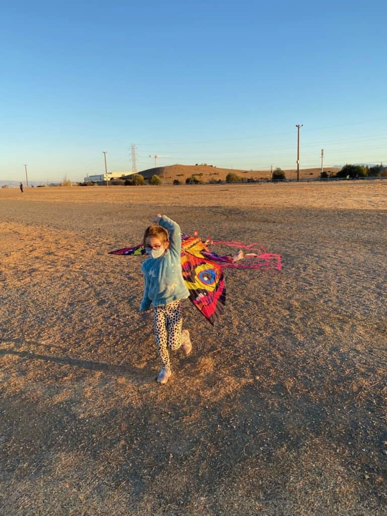 Lulu running with a kite as part of remote school project